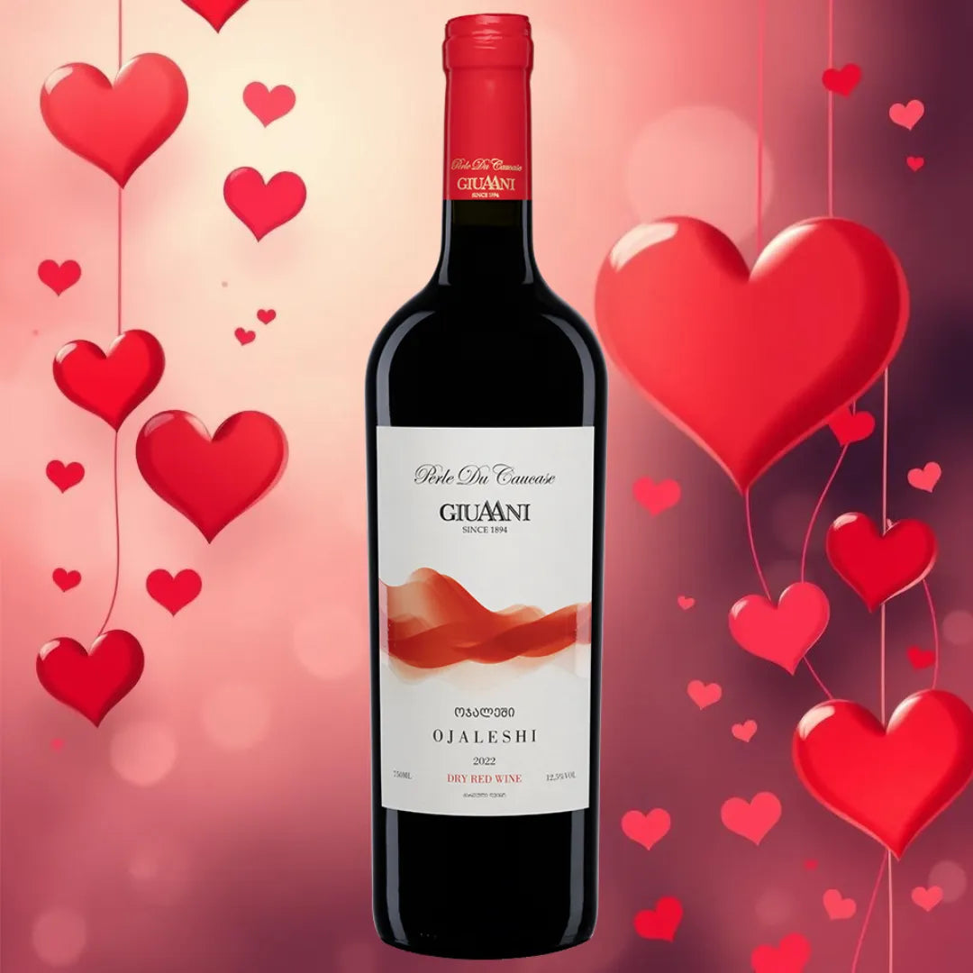 A bottle of Giuani Ojaleshi 2022 dry red wine with a romantic Valentine's Day background featuring red heart-shaped balloons and a soft pink gradient.