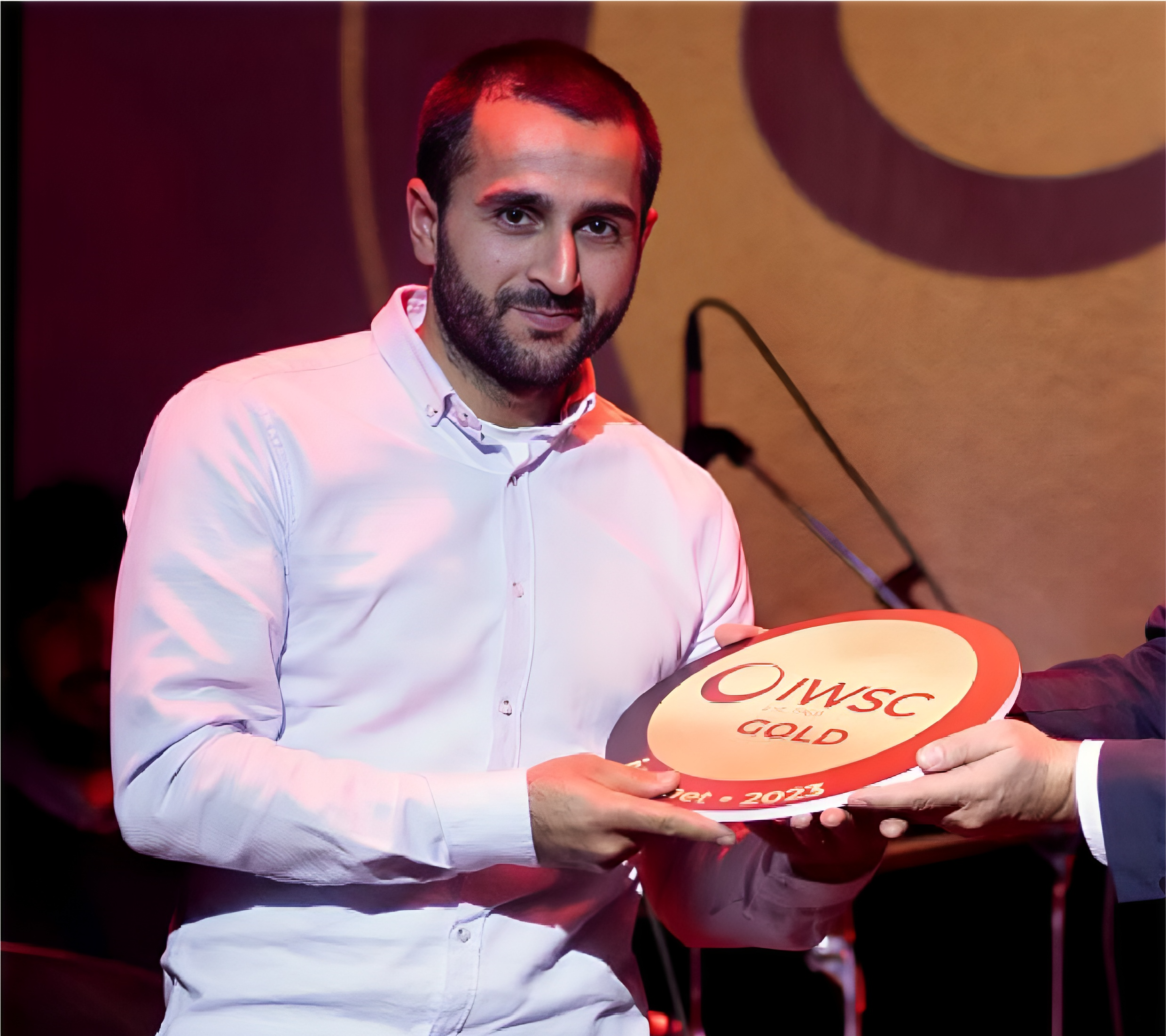 Giorgi Jmukhadze, Giuaani winemaker, holding an IWSC Gold award