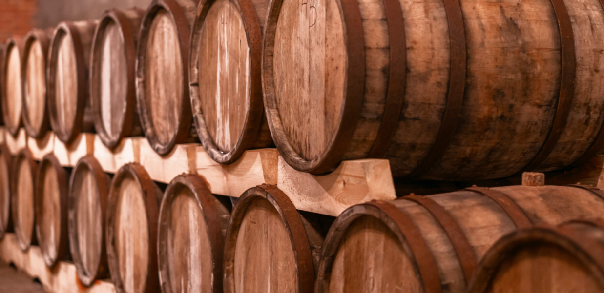 Stack of wooden wine barrels in a cellar at Giuaani winery