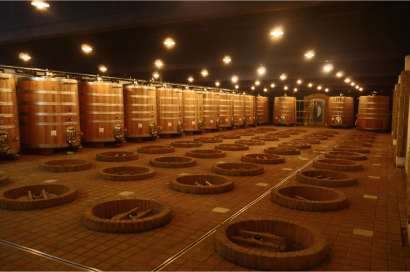 nterior of Marani Winery with large wooden barrels and qvevri for traditional winemaking