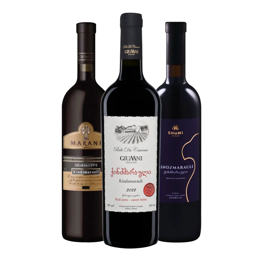 Three bottles of Kindzmarauli wine, each with a distinct label and color scheme, representing the Marani, Giuaaniki, and Shumi brands.